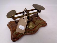 A set of ornate 19th century brass postal scales with graduated weights,