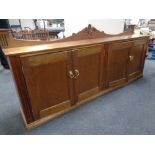 An Edwardian style four door low sideboard with brass handles