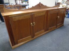 An Edwardian style four door low sideboard with brass handles