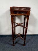 A reproduction Chippendale style fret work plant stand