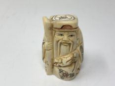 A carved Chinese bone netsuke - Gentleman carrying a sack of corn