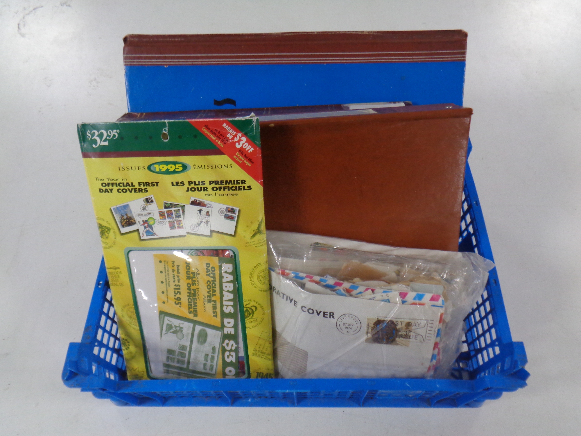 A basket containing three stamp albums containing 20th century stamps of the world,