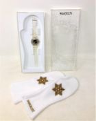 A Swatch Snow Your Time Away watch with mittens in box.