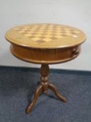 A reproduction pedestal chess board occasional table with pieces