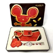 A Swatch Chinese New Year Mouse watch with bag in box.