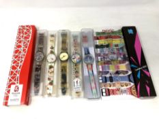 A group of five various Swatch watches in plastic cases, together with A Beijing 2002 watch,