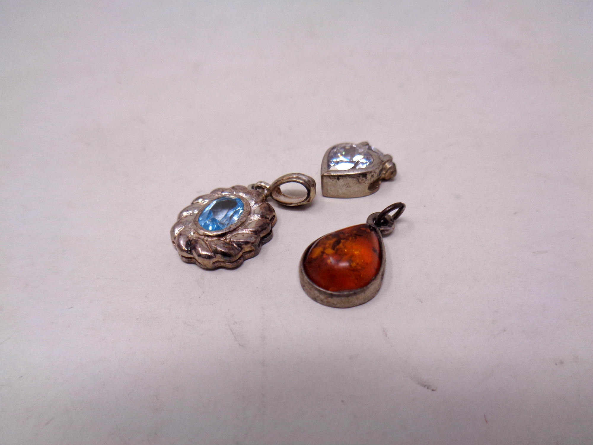 Three silver pendants