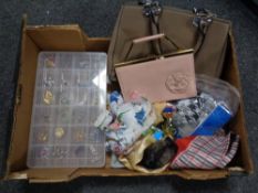 A box containing lady's handbags, scarves, perfumes,