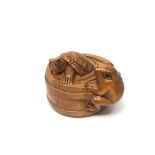 A carved Chinese hardwood netsuke - Frog and turtle in barrel