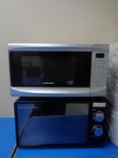 A Cookworks microwave together with a Russell Hobbs microwave and a quantity of pub trays