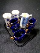 A tray containing Italian blue and gilt three piece mantel garniture set,