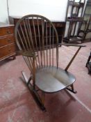 An Ercol solid stained elm and beech rocking chair
