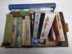 A box containing 20th century hardback books, Thesaurus, Rupert the Bear annual,