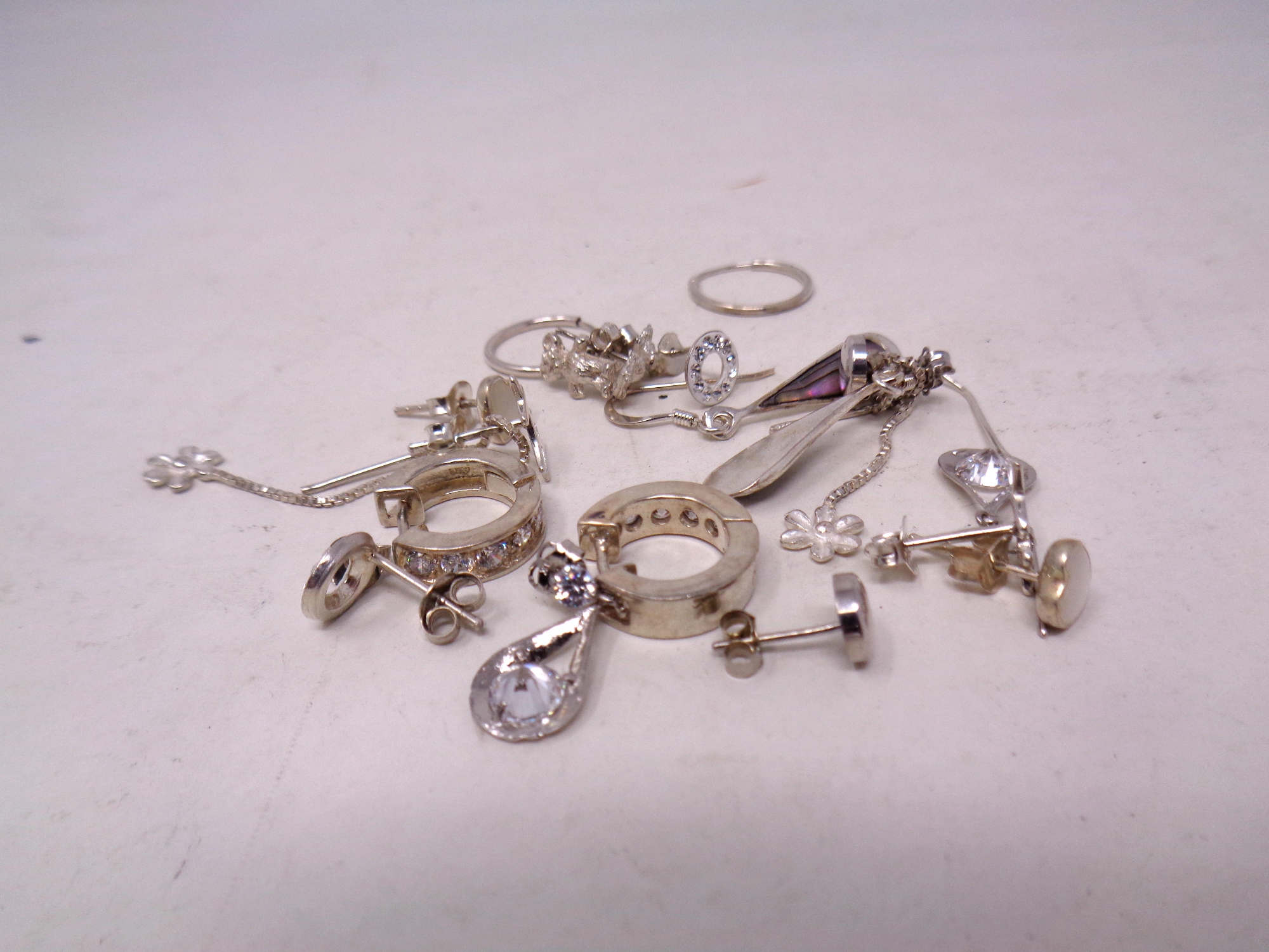 Ten pairs of silver earrings