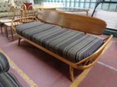 An Ercol solid elm and beech day bed/settee