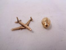 Two 9ct gold charms - aeroplane and rugby ball,