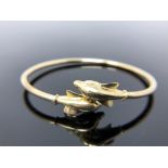 A 14ct gold dolphin bangle., 7.