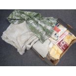 Two boxes containing bedding, blankets, wicker baskets,