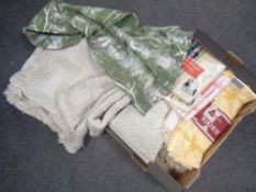 Two boxes containing bedding, blankets, wicker baskets,