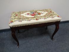 A stained beech wood dressing table stool with a floral tapestry seat