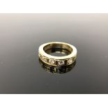 An 18ct gold diamond set half eternity ring, approximately 0.5 carat total weight, size I/J. 5.