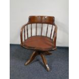 An Edwardian oak captain's style desk chair