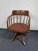 An Edwardian oak captain's style desk chair