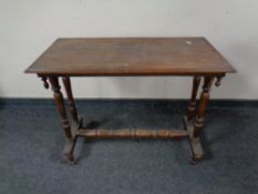 A late 19th century oak topped occasional table with under stretcher