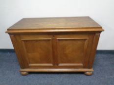 A continental oak fall front cabinet fitted internal drawers and shelves