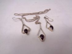 A silver pendant and chain together with earrings