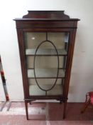 A late 19th century inlaid mahogany glazed door display cabinet on raised legs