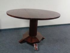 A Victorian circular tilt top table on octagonal pedestal