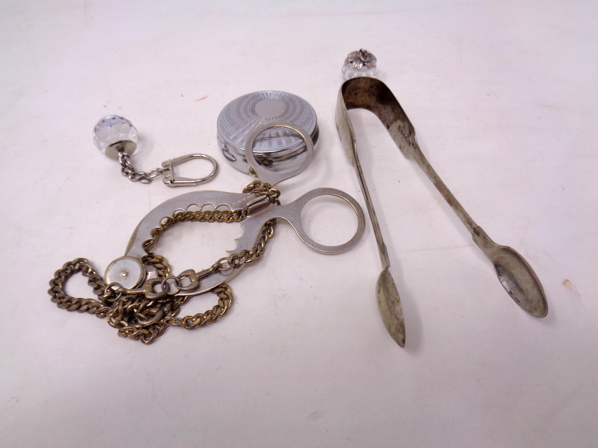 A small quantity of items including sugar tongs,