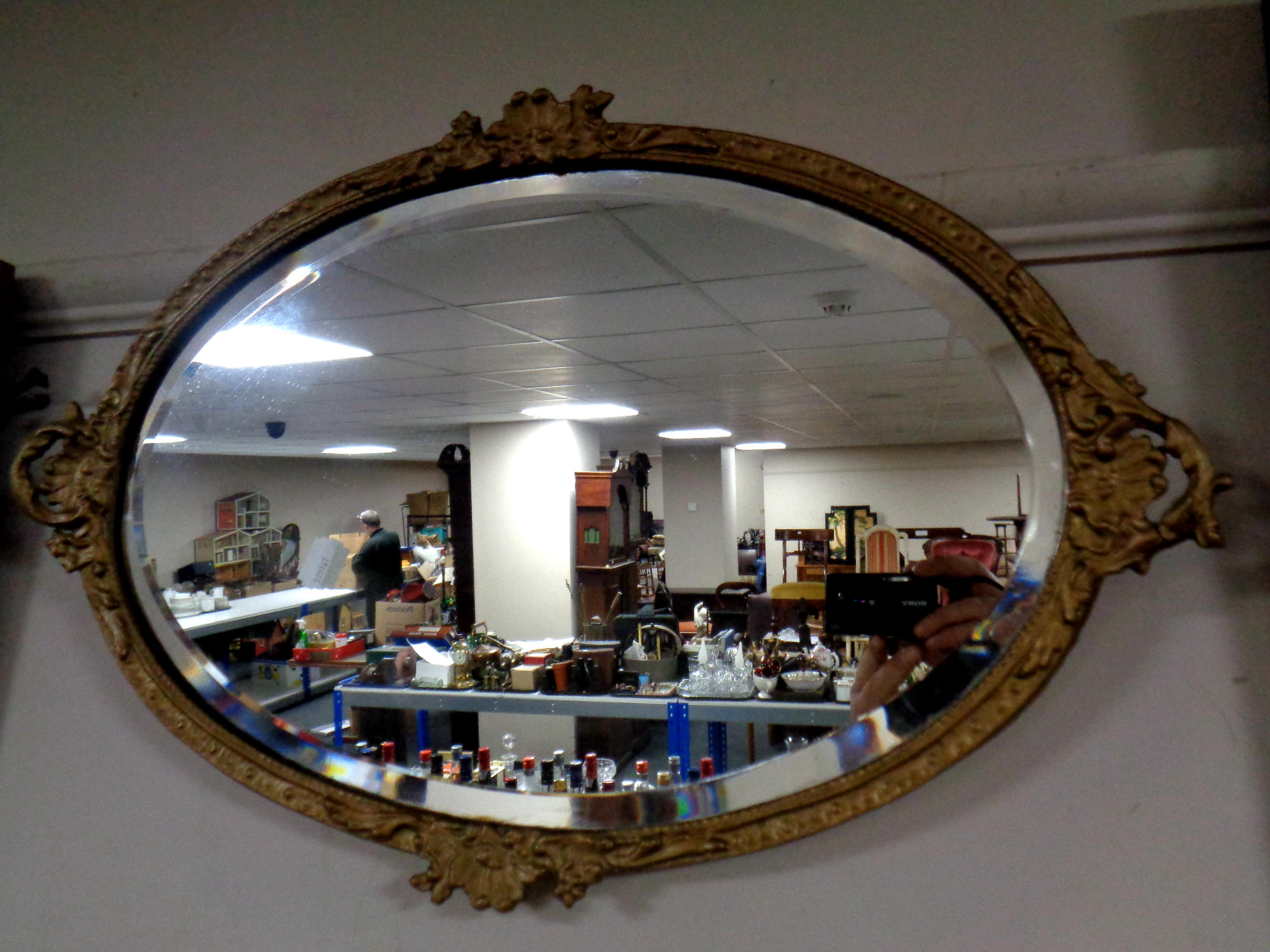 A 19th century oval bevel edged mirror in a gilt composite frame