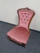 A Victorian mahogany lady's chair upholstered in a pink button back fabric