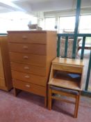 A mid 20th century teak six drawer chest together with a teak telephone table