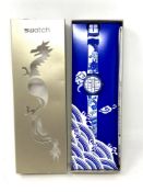 A Swatch Year of the Dragon watch in box.