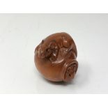 A carved Chinese hardwood netsuke - Two rats on a barrel