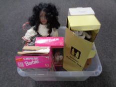 A box containing assorted dolls to include three Barbie Dolls of the World,