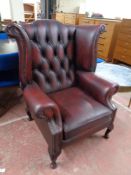 An oxblood button leather Chesterfield wingback armchair