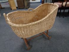 A 20th century wicker Moses basket on stand