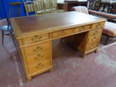 A 19th century oak twin pedestal writing desk fitted ten drawers with brass drop handles