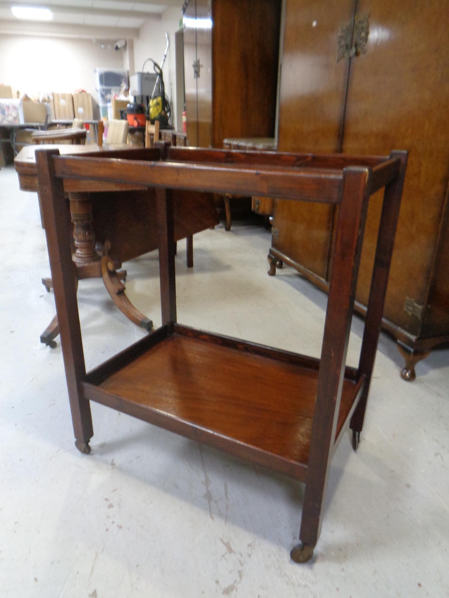 A two tier tea trolley on casters