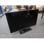 A Panasonic TX-L32X5B LCD TV with remote on stand,