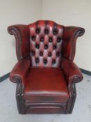 A red button leather Chesterfield wingback armchair