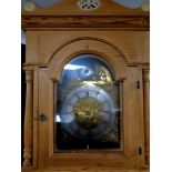 A continental stripped pine longcase clock with brass dial,