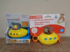 A box containing a quantity of Skip Hop and Munchkin bath toys