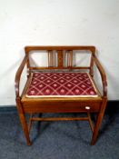 An Edwardian inlaid mahogany storage piano stool seat