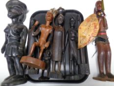 A tray containing a quantity of carved hardwood tourist tribal figures