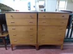 A pair of mid 20th century Austin suite teak five drawer chests